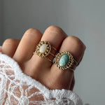 Bague Pauline portée en accumulation (stacking) avec une autre bague large à pierre blanche.