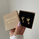 Paire de boucles d'oreilles pendantes Flora présentées dans leur écrin cadeau Maison de l'Amour.