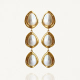 Paire de boucles d'oreilles pendantes Martina triple rangs style vintage avec pierres nacrées sur fond blanc.