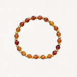 Bracelet fin perles Oranges et billes dorées sur fond blanc.