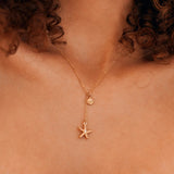 Collier en Y acier inoxydable doré, pendentifs coquillage et étoile de mer sertie d'un brillant.
