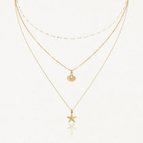 Collier 3 rangs en acier inoxydable doré, pendentifs étoile de mer et coquillage perlé.